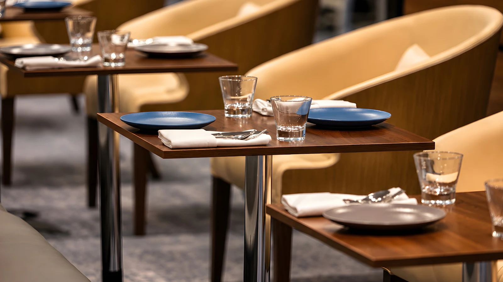 Set tables in a restaurant dining room
